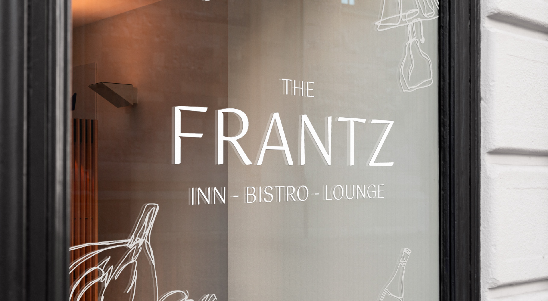Frantz logo written in white on a store front window